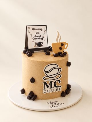 Coffee-themed grand opening cake with coffee cup and bean decorations on a warm ivory background