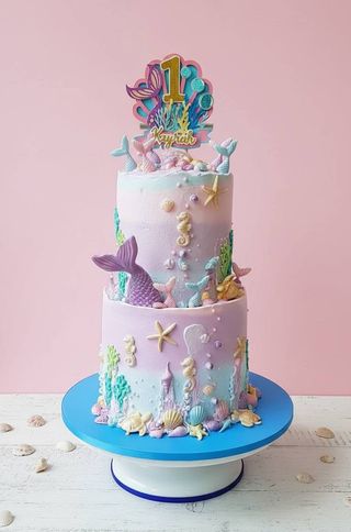 Two-tier pastel mermaid birthday cake with seashells and underwater details